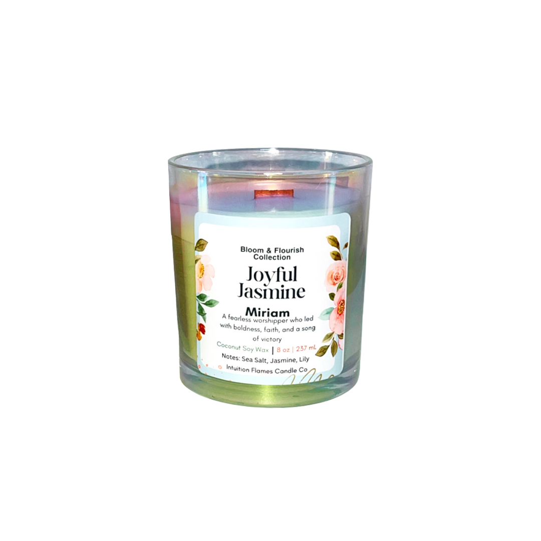 Intuition Flames Miriam candle from the Bloom and Flourish Collection, a 10 oz hand-poured coconut wax candle with a natural wood wick in an iridescent glass vessel. Features a radiant sea salt, jasmine, and lily petal fragrance inspired by the biblical prophetess Miriam. Clean-burning, toxin-free, perfect for worship, reflection, and spiritual growth.