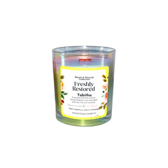 Intuition Flames Freshly Restored Tabitha candle, a 10 oz hand-poured coconut wax candle with natural wood wick in an iridescent glass vessel. Features a refreshing fragrance of sparkling grapefruit, lemon, and effervescent champagne inspired by biblical figure Tabitha. Clean-burning, toxin-free, perfect for spiritual renewal, worship, and reflection.